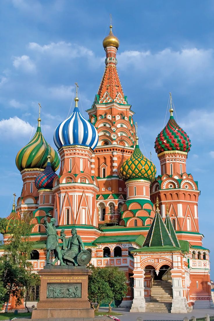 an ornate building with green and red domes