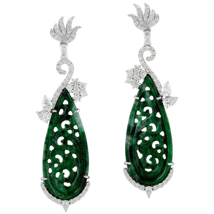 These stunning hand carved Jade earrings are crafted in 18-karat white gold. It is set in 18.5 carats Jade and 1.9 carats of sparkling diamonds. FOLLOW MEGHNA JEWELS storefront to view the latest collection & exclusive pieces. Meghna Jewels is proudly rated as a Top Seller on 1stDibs with 5 star customer reviews. All items manufactured by us are handmade and can be customized or redesigned. Composition Size-57X16 MM Total Weight-14.746 Gold Weight(Gms)-10.666 Diamond Wt(Cts)-1.9 Jade Wt(Cts)-18. Luxury Carved Earrings, Luxury Carved Earrings For Formal Occasions, Luxury Platinum Diamond Earrings Hallmarked, Luxury Earrings With Intricate Design, Elegant Carved Earrings For Formal Occasions, Luxury Diamond Earrings With Intricate Design For Anniversary, Elegant Silver Carved Earrings, Elegant Carved Drop Earrings, Luxury Carved Jewelry For Formal Occasions