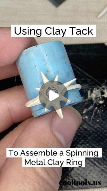 a hand holding a small metal clay ring with the words using clay tack to assemble a spinning metal clay ring