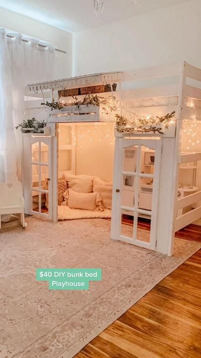 a room with bunk beds, couches and lights on the ceiling is decorated in white