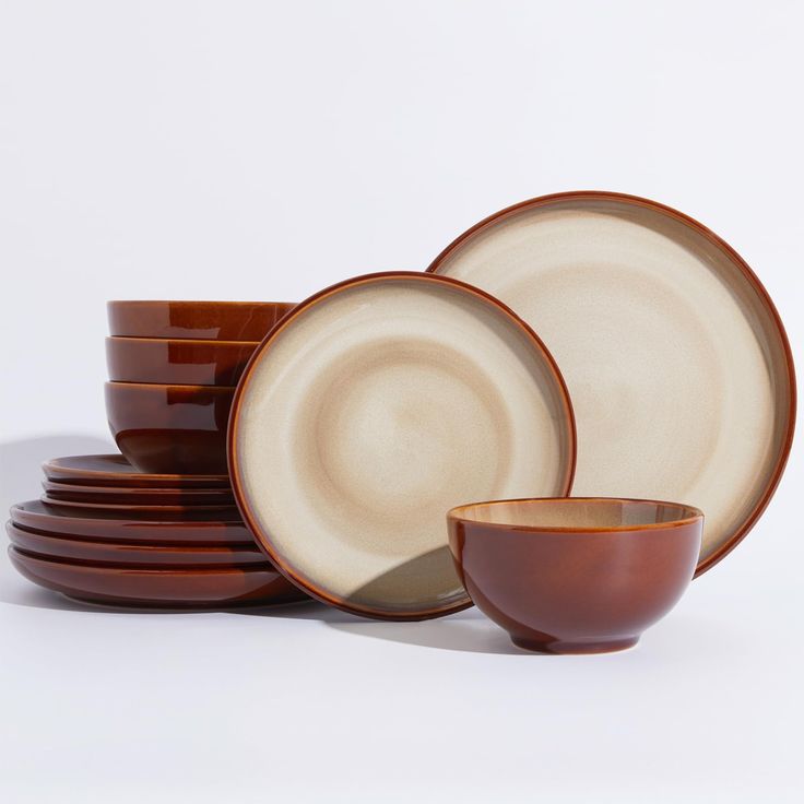 a stack of brown and white dishes