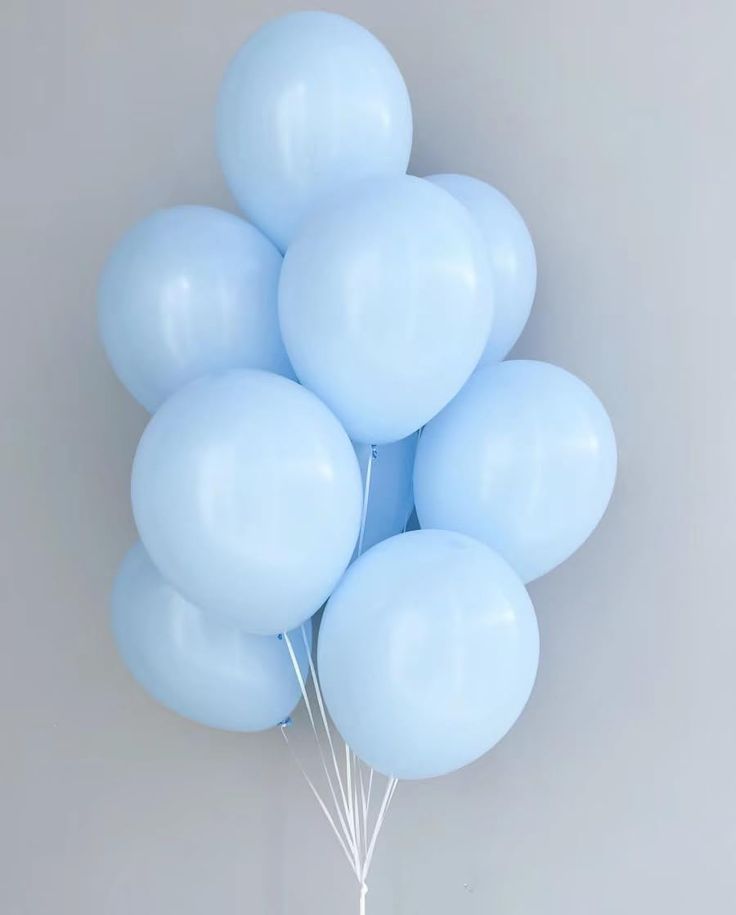 a bunch of blue balloons floating in the air