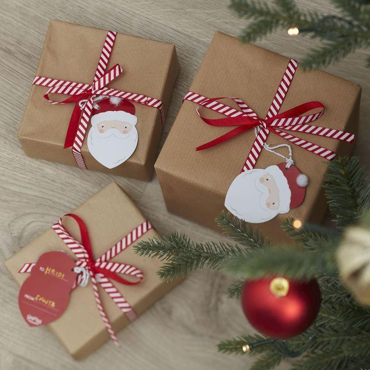 two presents wrapped in brown paper and tied with red ribbon