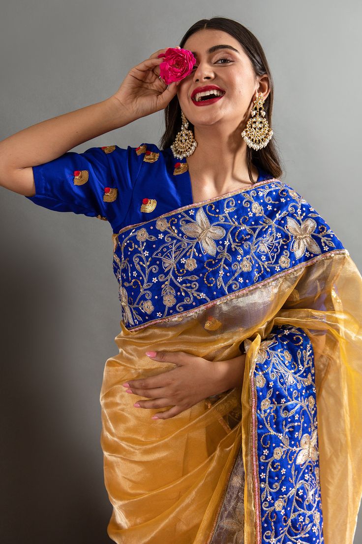 Yellow saree with an woven solid base highlighted by blue sequin aari embroidered butterflies and flower motifs. Comes with contrast embroidered blouse.
Components: 2
Pattern: Embroidered
Type Of Work: Aari, Sequins 
Neckline: Round
Sleeve Type: Half
Fabric: Tissue
Color: Yellow,Blue
Other Details: 
Heavy border
Placed embroidery
Occasion: Sangeet,Wedding - Aza Fashions Designer Organza Blouse With Dori Work, Organza Blouse With Dori Work For Festivals, Festive Organza Blouse With Dori Work, Festival Organza Blouse With Dori Work, Traditional Organza Blouse Piece With Dori Work, Festive Organza Blouse Piece With Dori Work, Blue Tissue Silk Saree With Dori Work, Traditional Organza Saree With Unstitched Blouse, Traditional Organza Blouse Piece For Navratri