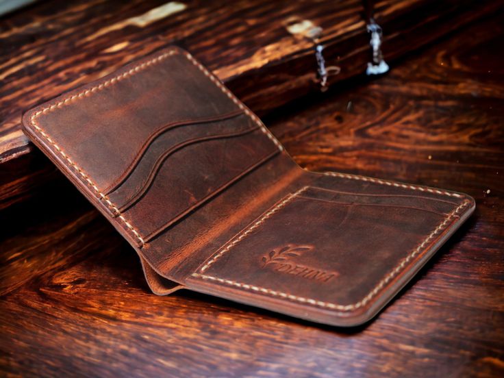 As DEHNA, we are excited to bring you our handcrafted leather wallets and bracelets. Our handmade and unique products are not just accessories, they are designed as special pieces that will reflect your style and personality. DEHNA is taking great steps towards becoming a brand that stands out with its sensitivity to quality and reliability. In each of our products, we bring together the highest quality materials and meticulous workmanship. Our aim is to provide our valued customers with long-lasting and elegant products and to ensure that you enjoy every use. In this journey full of surprises, we aim to grow and develop even more with your support. Together with you, we are excited to be a community that grows stronger every day. We hope you will not leave us alone in this adventure and b Handmade Brown Wallet For Everyday Carry, Handmade Leather Wallets For Everyday Carry, Handmade Vintage Wallets For Everyday Use, Vintage Handmade Trifold Wallet For Everyday, Artisan Trifold Wallet With Card Slots For Daily Use, Handmade Brown Card Holder For Everyday Use, Handmade Rustic Wallet For Everyday Use, Rustic Leather Wallets With Card Slots, Handmade Vintage Wallet