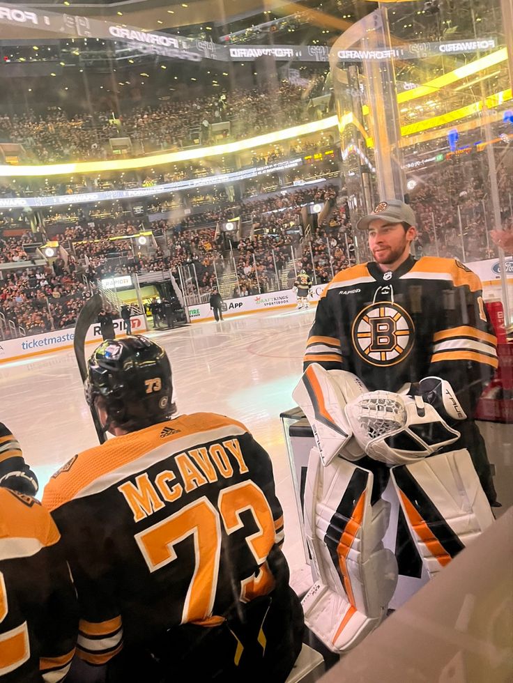 the hockey players are sitting on the bench