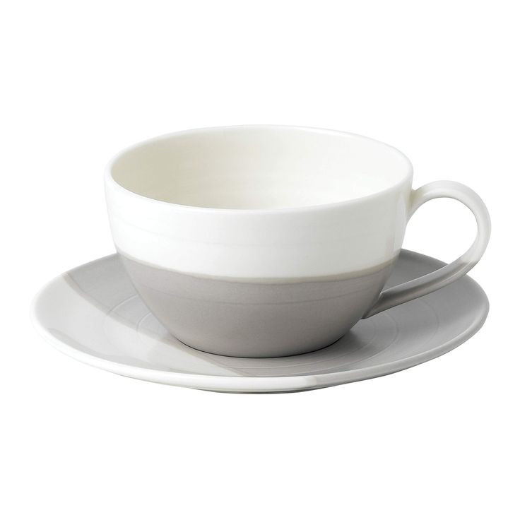 a white cup and saucer sitting on top of a plate