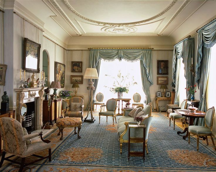 a living room filled with lots of furniture next to a fire place in a house