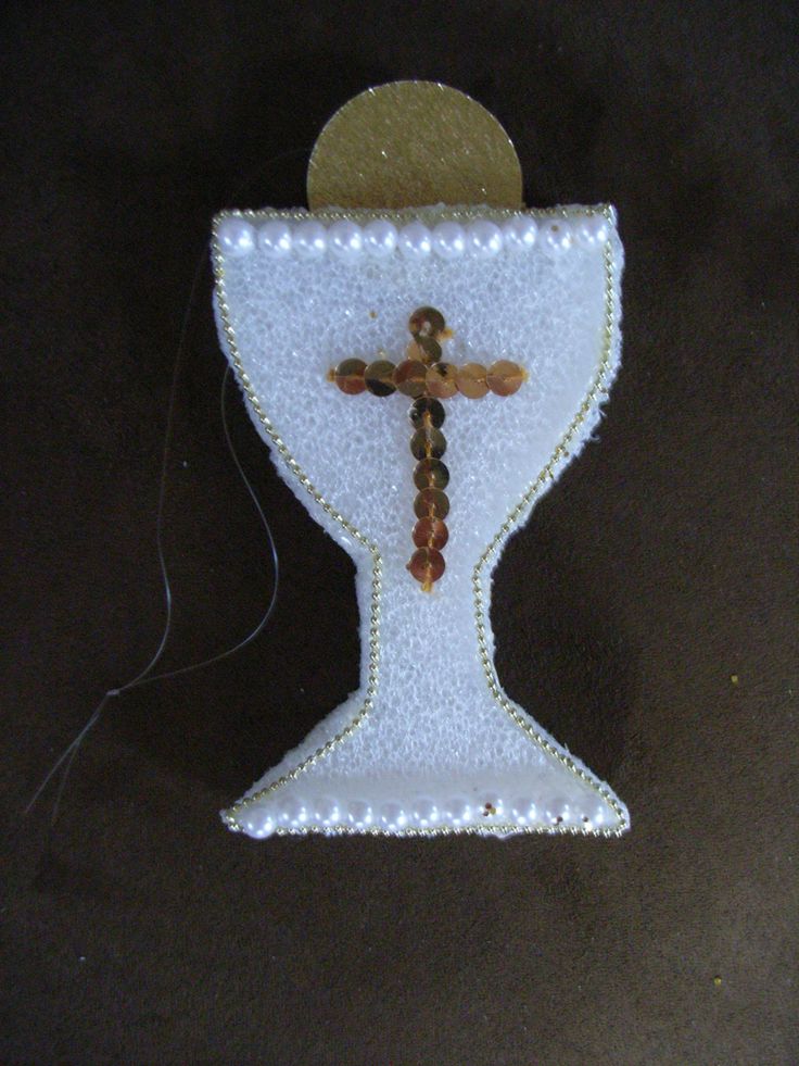 a cross on the side of a white vase