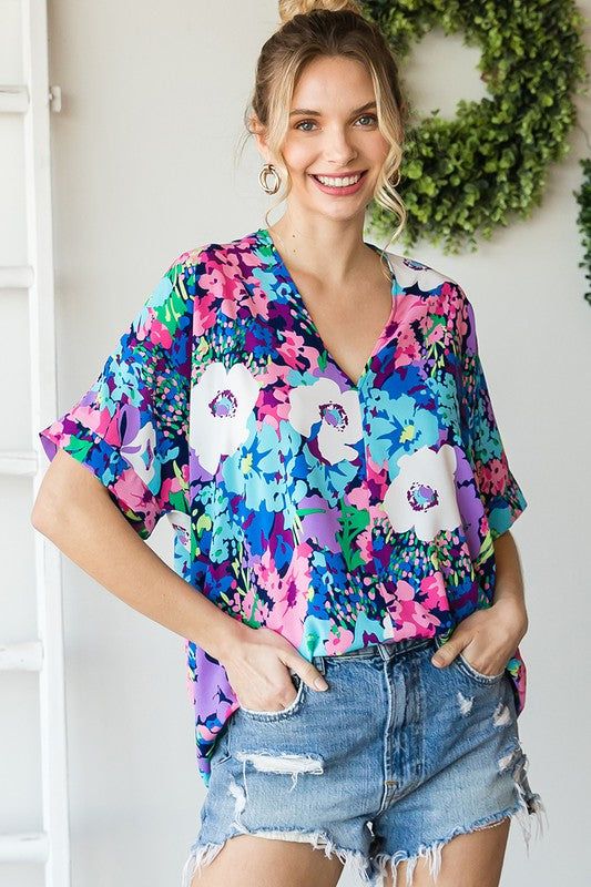 Floral print boxy top with a V-neckline and short sleeves.- Unlined, non-sheer, lightweight.- Model is 5'8'' and is wearing a Small. 100% Polyester Spring V-neck Top For Day Out, Spring V-neck Top For Day Out With Relaxed Fit, Spring Relaxed Fit V-neck Top For Day Out, Trendy V-neck Blouse With Vibrant Print, Trendy V-neck Blouse With Graphic Print, Casual Floral Print V-neck Top For Summer, Relaxed Fit V-neck Top For Summer Day Out, Spring Beach V-neck Top With Short Sleeves, Summer Short Sleeve Blouse With Graphic Print