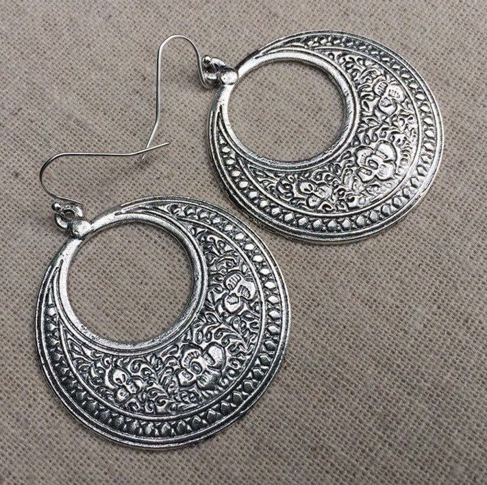 "These are fabulous and chic boho floral hoop earrings!  Make a statement without saying a word with these versatile earrings.  Perfect for everyday wear, dress them up or down! The hoops measure 1 5/8\" long by 1 1/2\" wide.  They hang from simple silver ear wire hooks.  Overall drop length is just under 1 3/4\".  Made from plated silver. I have this same earring style also available in gold. Here is a direct link to those... https://www.etsy.com/listing/1524279410/ Thanks so much for stopping Silver Boho Earrings, Big Silver Earrings, Big Dangle Earrings, Bohemian Flower, Boho Hoop Earrings, Statement Hoop Earrings, Earrings Big, Statement Drop Earrings, Disc Earrings