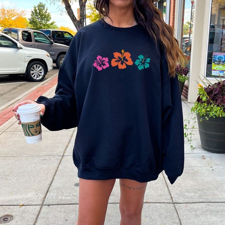 Get ready for summer in style with the Hibiscus Flower Sweatshirt, featuring an oversized, trendy Y2K vibe that perfectly combines preppy clothing with a beachy, coconut girl aesthetic. Whether you're looking for a cozy crewneck sweater or a statement piece to layer over your summer shirts, this sweatshirt is a must-have for any VSCO girl wardrobe.   *USUALLY SHIPS WITHIN 1-4 DAYS* -Gildan crewneck sweatshirt -For oversized look size up 1-2 sizes -Comfy & Cozy -Ink designs -Collar is ribbed knit Trendy Spring Beach Sweatshirt, Trendy Sweatshirt For Beach In Spring, Oversized Trendy Sweatshirt For Beach Season, Trendy Oversized Sweatshirt For Beach Season, Oversized Sweatshirt For Beach Vacation, Oversized Sweatshirt For Beach Season Vacation, Oversized Spring Beach Sweatshirt, Oversized Sweatshirt For Beach In Spring, Oversized Sweatshirt For Spring Beach Outings