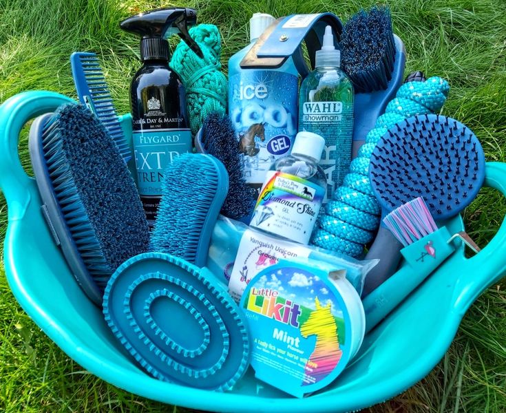 a blue tub filled with lots of different types of hair products and grooming items