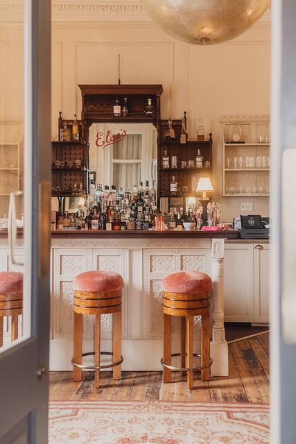 two stools are in front of the bar