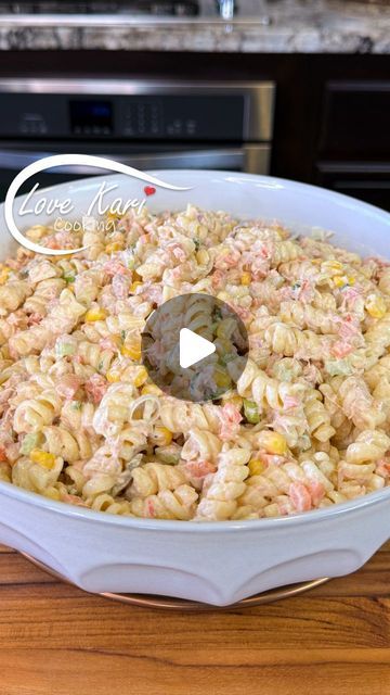 macaroni salad in a white bowl on a wooden table