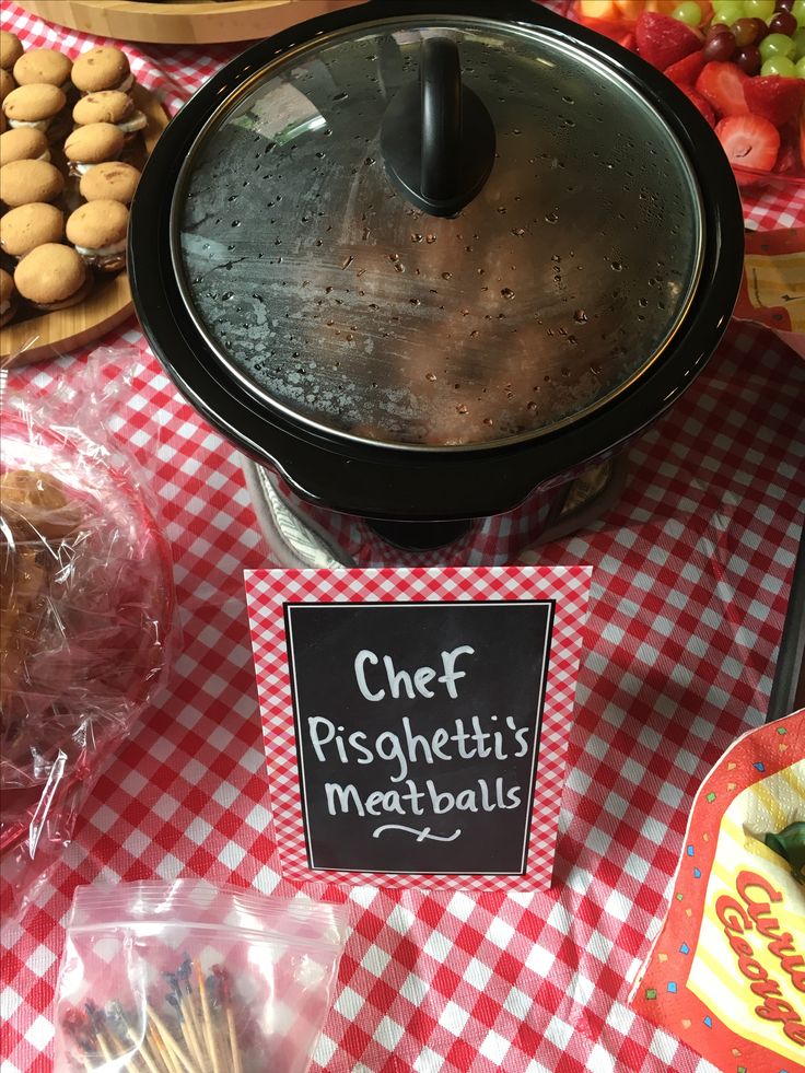 a table topped with lots of different types of food on top of a red and white checkered table cloth