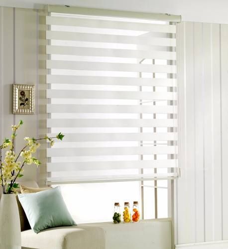 a living room with white walls and striped blinds