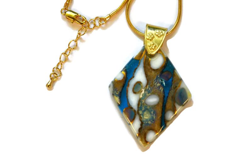 "You will really make a statement while wearing this eye-catching one of a kind, necklace. If you are looking for a unique gift, this necklace would make a great choice. I created this pendant, giving it a stone look by combining different colors of glass frit (crushed glass). The aqua blue is cathedral, which is transparent as you can see in the 2nd photo. I added a few pieces of 99.9% pure silver foil that cause a unique reaction when added to the glass. I then fired it in one of my kilns and Blue Large Pendant Jewelry For Anniversary, Modern Blue Jewelry With Unique Variations, Blue Jewelry With Large Pendant For Anniversary, Blue Necklace With Large Pendant For Anniversary, Blue Anniversary Necklaces With Large Pendant, Artistic Blue Jewelry With Large Pendant, Blue Jewelry For Art Collection, Unique Blue Jewelry With Large Pendant, Unique Blue Necklace With Large Pendant