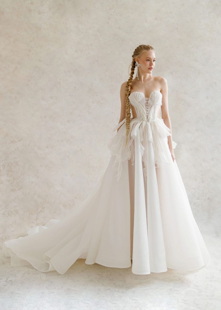 a woman in a white wedding dress with long hair