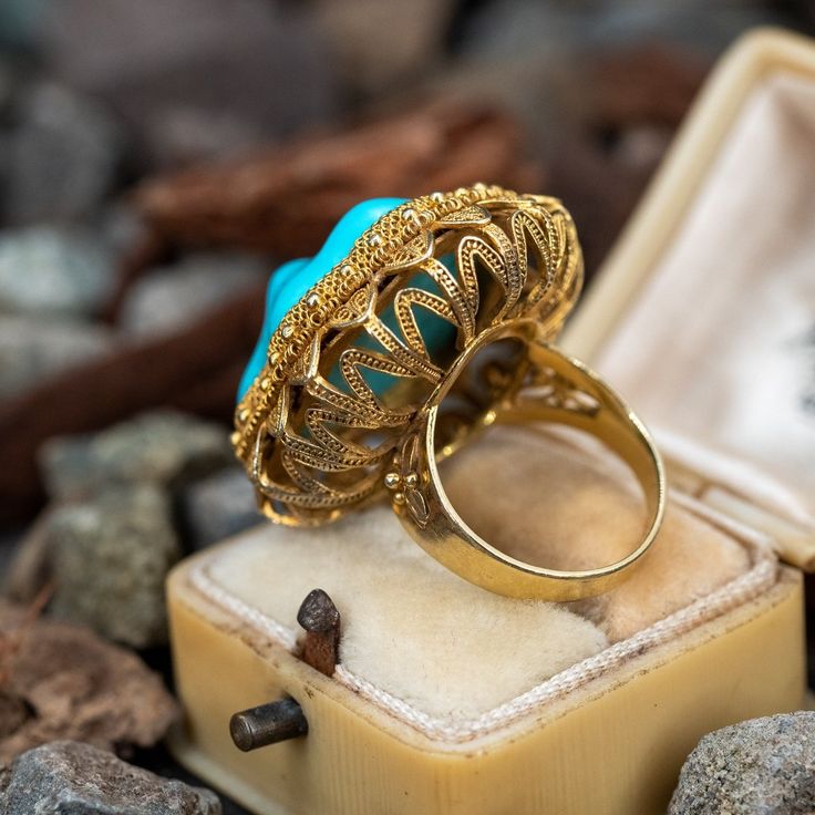 This incredible turquoise cocktail ring is crafted of 14k yellow gold and features stunning detailing. The ring is currently a size 6. Luxury Turquoise Cabochon Ring In Yellow Gold, Luxury Yellow Gold Turquoise Cabochon Ring, Luxury Turquoise 14k Gold Ring, Luxury Yellow Gold Turquoise Ring For Formal Occasions, Luxury 14k Yellow Gold Turquoise Ring, Gold Vintage Turquoise Ring For Formal Occasions, Vintage Gold Turquoise Ring For Formal Occasions, Gold Vintage Turquoise Ring For Formal Events, Vintage Gold Turquoise Ring For Formal Events