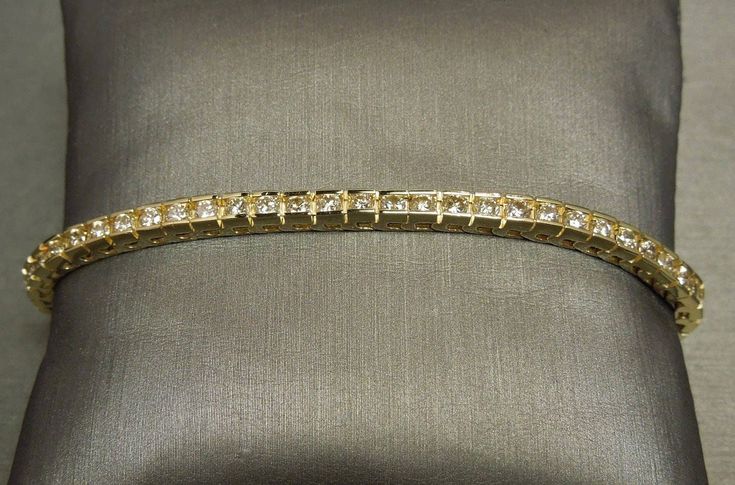 Vintage Circa 1980 In an Art Deco Style Constructed of 14KT Yellow Gold Containing 60 Channel set Genuine Earth-Mined Slightly Included Round Brilliant cut Natural Fancy Champagne Diamonds weighing a total of approximately 3.00 carats VVS2-SI2 Clarity Bracelet measuring approximately 7" in length Measuring approximately 3.2mm in width With a 14KT Yellow Gold clasp + safety  Weighing 12.1 grams Clasp stamped: 14K *Sale of bracelet includes an appraisal certificate for your insurance purposes.  Al Gold Classic Diamond Bracelet For Formal Occasions, Classic Yellow Gold Evening Bracelet, Classic Yellow Gold Bracelet For Evening, Gold Brilliant Cut Bracelet For Anniversary, Timeless Gold Tennis Bracelet For Wedding, Classic Gold Tennis Bracelet For Wedding, Classic Hallmarked Tennis Bracelet For Formal Occasions, Gold Timeless Tennis Bracelet For Wedding, Classic Formal Gold Bracelet Hand Set