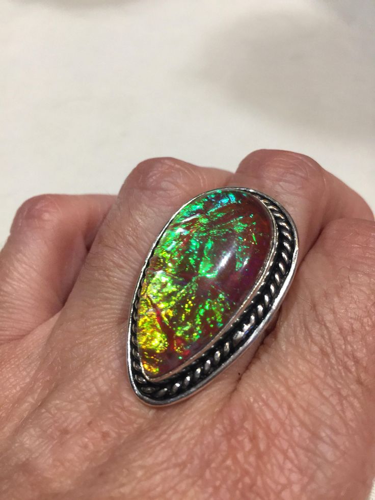 Large dichroic art glass Vintage ring Low content silver not sterling. All rings are shipped in a nice gift box. Check out our over a THOUSAND great reviews Engraving is $4 per letter and is not always perfect depending on the piece. It can take a few days if the jeweler is busy. This is payable to Paypal Judithsltd@gmail.com Multicolor Polished Finish Rings For Gift, Multicolor Polished Rings As A Gift, Multicolor Polished Rings Perfect As Gift, Multicolor Polished Rings For Gifts, Iridescent Spiritual Rings As Gifts, Collectible Iridescent Cabochon Jewelry, Iridescent Cabochon Ring As Gift, Iridescent Cabochon Rings As Gift, Round Opal Ring With Natural Inclusions For Gift