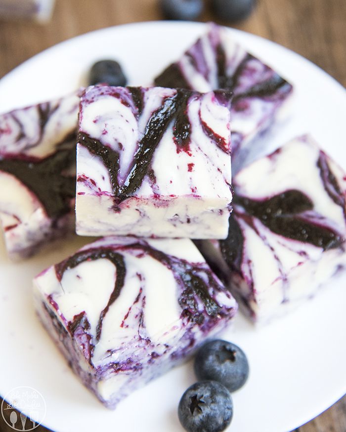 four pieces of blueberry cheesecake on a white plate