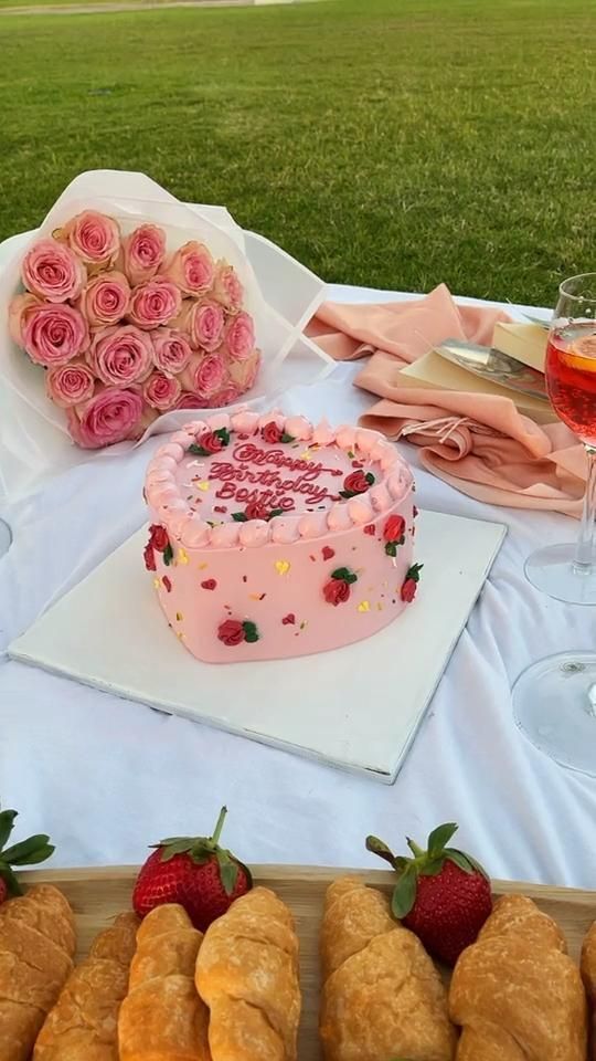 a table topped with lots of pastries and a cake next to some wine glasses