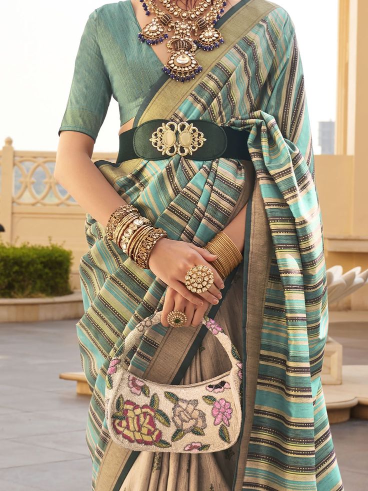 This beautiful multi-color printed silk traditional saree with a teal blue color silk blouse is a stunning choice for weddings, festivals, and other special occasions. The saree features intricate digital printwork, making it a standout piece in any crowd. The 5.50 meters of saree and unstitched blouse material ensure a perfect fit for any body type.
The vibrant multi-color design is eye-catching and perfect for adding a pop of color to any event. The intricate print work adds a touch of eleganc Elegant Multicolor Pre-draped Saree With Printed Border, Festive Bohemian Blouse With Zari Weaving, Green Pre-draped Saree With Printed Border For Navratri, Bohemian Multicolor Pre-draped Saree For Traditional Ceremonies, Green Pre-draped Saree With Printed Motifs, Multicolor Printed Motifs Blouse For Wedding, Multicolor Printed Blouse For Wedding, Elegant Multicolor Pre-draped Saree With Printed Motifs, Multicolor Printed Wedding Blouse