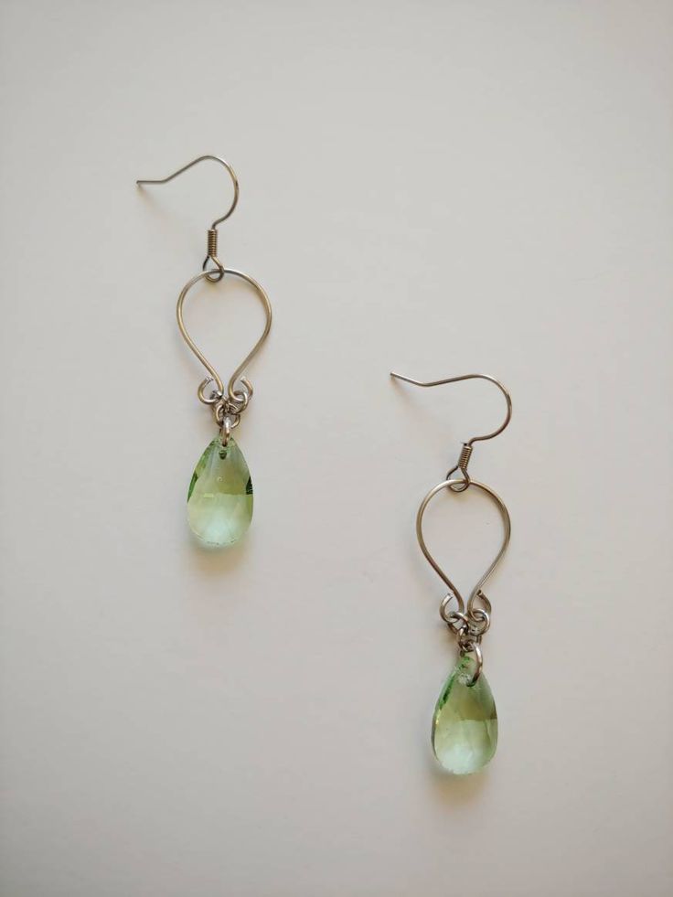 "Simple, yet flattering, wire wrapped earrings with multifaceted teardrop glass beads. Made with 100% stainless steel wire and earring hooks. They hang approximately 1.75\" down from earring hook. Earrings will come on an earring card with plastic earring backs. *Note: this listing is for one pair of earrings. Please choose color below. All my jewelry is handmade, and made with patience, care and love. In the unlikely event that it needs to be repaired, I'll do it free of charge." Czech Glass Teardrop Earrings With Ear Wire, Nickel-free Czech Glass Teardrop Earrings, Nickel-free Teardrop Czech Glass Earrings, Handmade Czech Glass Teardrop Earrings, Nickel-free Czech Glass Teardrop Earrings As Gift, Hypoallergenic Czech Glass Teardrop Earrings, Hypoallergenic Teardrop Czech Glass Earrings, Czech Glass Teardrop Earrings Gift, Teardrop Czech Glass Wire Wrapped Jewelry