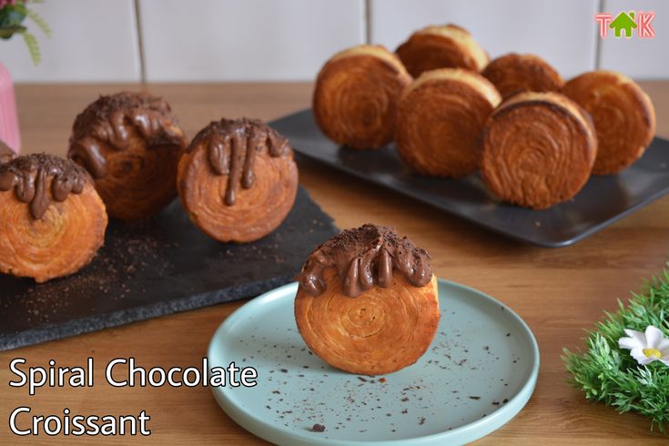 some pastries are sitting on black trays