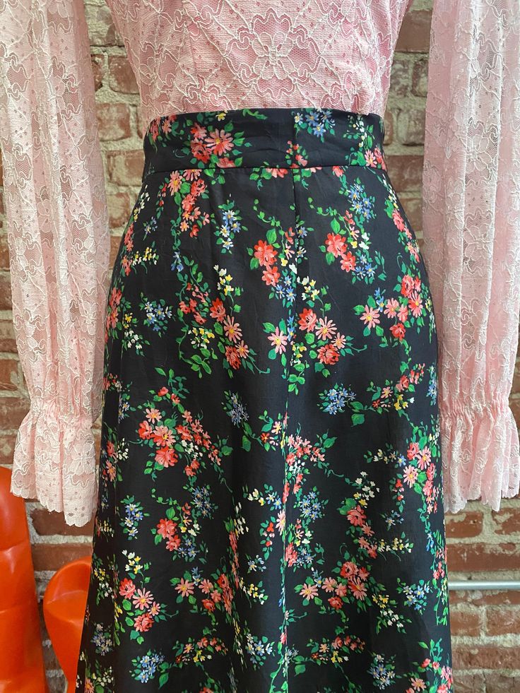 "70s Black Floral High Waisted Long A Line Cotton Skirt. Exquisite seventies cotton black floral high waist skirt. The cotton fabric is incredible, so heavenly with a stunning black floral print. The a line cut is so flattering. In perfect condition. I love this skirt. 27\" waist 42\" hip 41\" length Feel free to message me with any questions. I'm happy to help and quick to respond. 🍎 Stay in touch @look.vintage" Vintage Flared Skirt For Spring, Vintage Cotton Floral Print Skirt, Vintage Floral Print Midi Skirt, Vintage Cotton Skirt With Floral Print, High Waist Floral Print Relaxed Skirt, Vintage A-line Skirt For Spring, Vintage A-line Spring Skirt, Retro Black Flared Skirt, Retro Floral Print Skirt