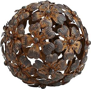 a metal ball with leaves and flowers on it