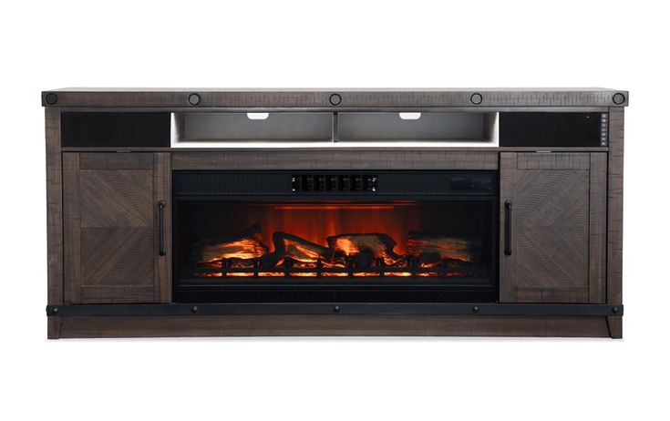 an entertainment center with a fire place and television on the front, in dark wood