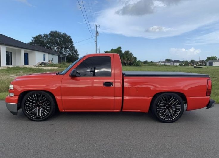 a red truck parked in front of a house