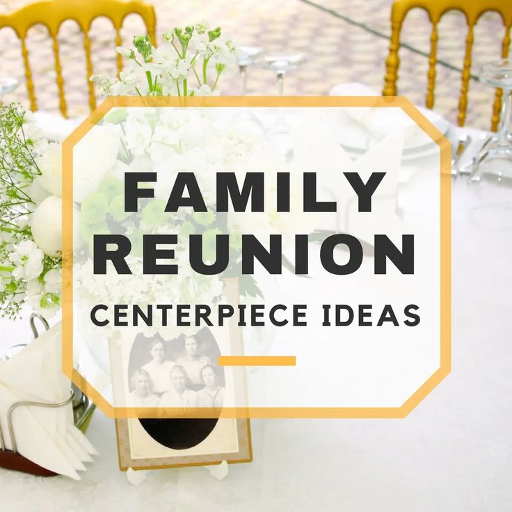 the family reunion centerpiece is surrounded by white flowers and greenery on a table