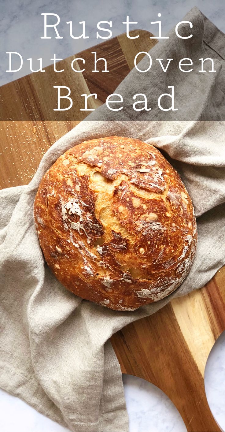 rustic dutch oven bread on a cutting board with text overlay that reads rustic dutch oven bread