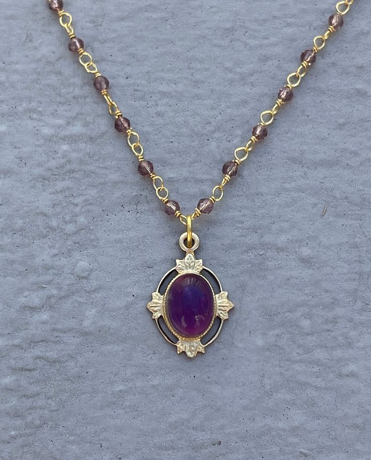 This vintage-inspired necklace is handmade using a 2mm genuine amethyst wire-wrapped chain and a 12x17mm pendant with an authentic 6x8mm amethyst. Amethyst promotes peace, clarity and cleanses energy.  The necklace comes in a ribbon-wrapped box, ready to be gifted. If you would like to leave a note for the recipient, you can do so during checkout. Please note that each stone is unique and varies in color. Oval Gold Wire Wrapped Necklaces, Gold Oval Wire Wrapped Necklace, Lavender Beaded Chain Jewelry For Gifts, Elegant Gold Amethyst Crystal Necklaces, Oval Gold Wire Wrapped Necklace, Handmade Amethyst Gold Necklace, Gold Amethyst Jewelry With Delicate Chain, Handmade Gold Amethyst Necklace, Gold Amethyst Bohemian Necklace