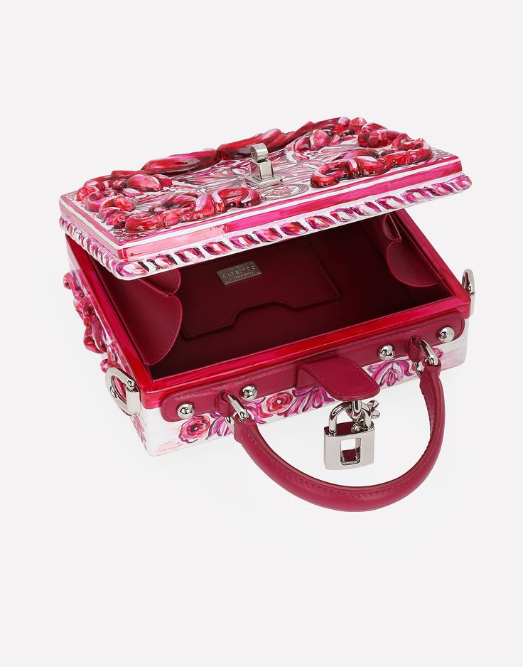 Dolce Box bag in hand-painted resin: Fuchsia Padlock fastening in palladium-electroplated metal with enamel flower embellishment Top handle and adjustable, detachable strap in polished calfskin Calfskin lining and inner pocket with concealed magnetic closure Item comes with special packaging Measurements: H14.5 x W19 x D7 cm Made in Italy The difference in the print placement that you may find on this product is a feature of Dolce & Gabbana’s “Handmade” pieces. A detail that makes every garment or accessory unique and exclusive. Luxury Pink Box Bag For Gift, Luxury Multicolor Box Bag With Detachable Handle, Designer Pink Box Bag With Detachable Handle, Designer Pink Rectangular Case Bag, Luxury Silver Box Bag, Luxury Rectangular Bags For Fashion Events, Luxury Red Box Bag For Gift, Designer Red Box Bag For Gift, Designer Pink Box Bag For Evening