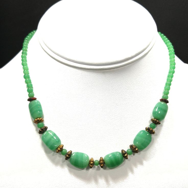 *Description: This necklace is made from faux jade green glass beads that have small air bubbles in them from the 1930s or before. They would be perfect to restring as they are most likely antique beads and the metal plated findings did not hold up as well as the glass beads. Unchecked from a gem tester, you would believe these to be jade but they are indeed glass. Looking closely with a loop, you can see the air bubbles within many of the glass beads. The necklace is 15 inches in length. This w Green Jade Emerald Necklace With Polished Beads, Green Emerald Necklace With Polished Jade Beads, Vintage Jade Beaded Necklace, Green Chrysoprase Single Strand Beaded Necklace, Green Single Strand Chrysoprase Beaded Necklace, Elegant Green Chrysoprase Beaded Necklaces, Vintage Jade Bead Necklaces, Vintage Jade Necklaces With Round Beads, Vintage Single Strand Jade Jewelry