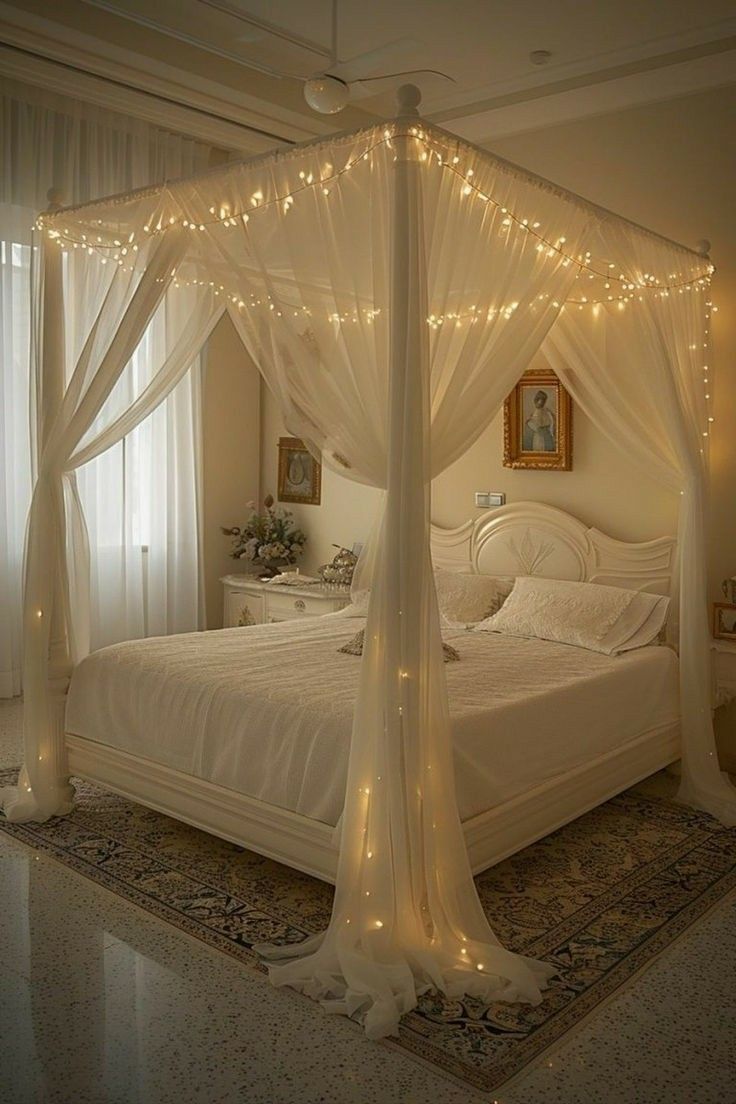 a bed with white sheets and lights on the headboard is in a room that has carpeted flooring