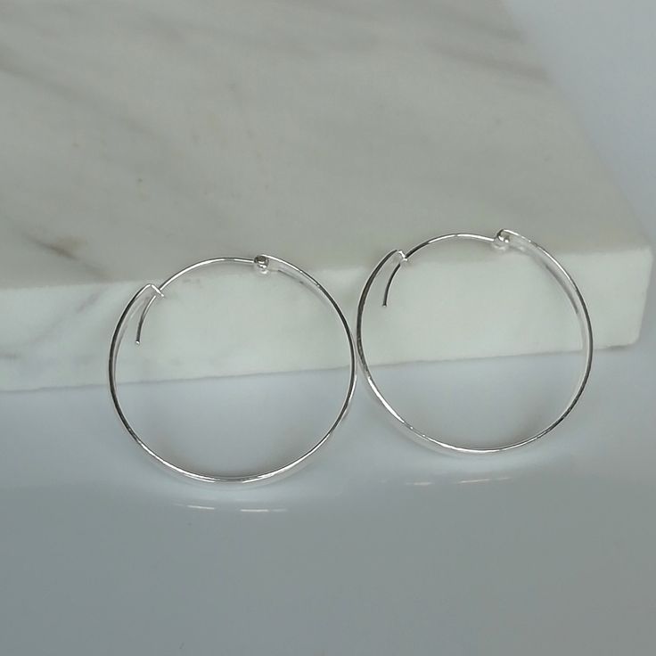 These are big sterling silver hoops, with a flat surface. Dimensions: 4 X 35 mm Weight: 5.2 gm These earrings are made of 925 hypoallergenic sterling silver. All my pieces are sent in a gift box. I can include a personal message from you if needed. You are welcome to contact me at... bhavnakwintra1956@gmail.com More Silver Hoops: https://www.etsy.com/your/shops/TheSilverGame/tools/listings/section:26305414 More Silver Earrings: https://www.etsy.com/your/shops/TheSilverGame/tools/listings/section Simple Adjustable Sterling Silver Hoop Earrings, Minimalist Small Hoop Earrings In Metal, Minimalist Small Hoop Clip-on Earrings, Minimalist Small Hoop Metal Earrings, Minimalist Small Metal Hoop Earrings, Hypoallergenic Sterling Silver Hoop Earrings, Minimalist Hypoallergenic Metal Hoop Earrings, Adjustable Minimalist Circle Hoop Earrings, Minimalist Adjustable Circle Hoop Earrings