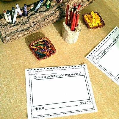 some pencils are sitting on a table next to an open book and other items