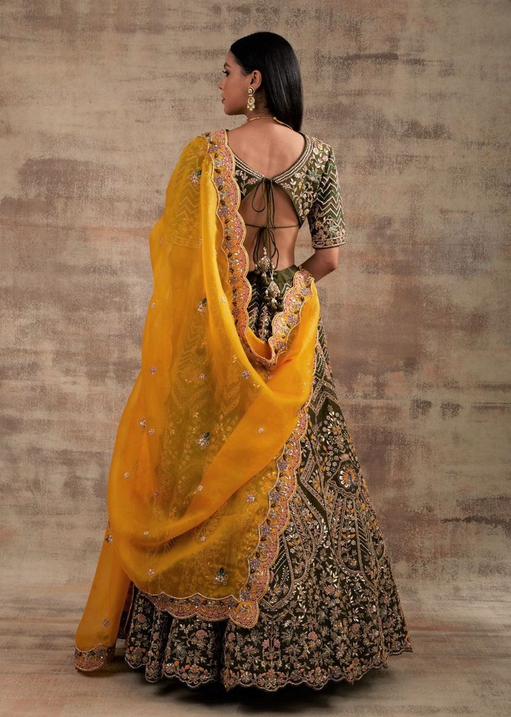 Choose a royal touch with this Pesto Green lehenga Shringarmati from Jannat Collection Are you struggling with the thought of what to wear on your special occasions? Look no further than this super-stylish pesto green color lehenga. This outfit is the game-changer that looks regal, royal and splendid. The most impressive thing about this lehenga is that it looks heritage, traditional and glamorous at the same time. Pepped up with Dori and gotta embroidery work, this lehenga will make you look li Transitional Tissue Silk Lehenga With Traditional Drape, Transitional Traditional Drape Tissue Silk Lehenga, Transitional Lehenga With Intricate Embroidery In Tissue Silk, Transitional Tissue Silk Lehenga With Intricate Embroidery, Traditional Tissue Silk Lehenga, Transitional Tissue Silk Lehenga For Wedding, Wedding Silk Gown With Cutdana, Silk Lehenga With Sheer Dupatta For Wedding, Wedding Silk Lehenga With Sheer Dupatta