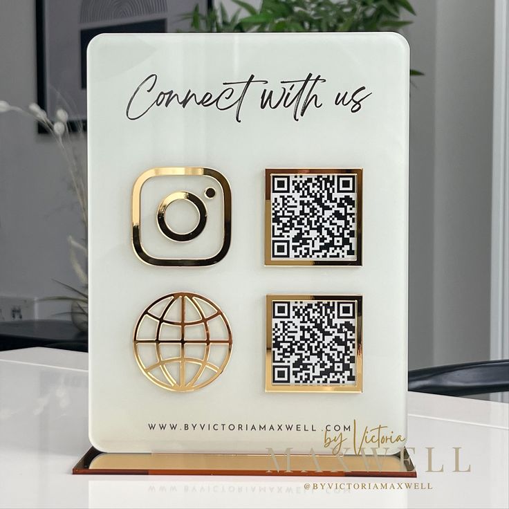 a white sign with black and gold stickers on it that says connect with us