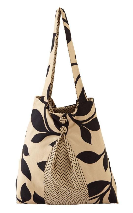 a black and white handbag with an abstract design on the front, tied in a knot