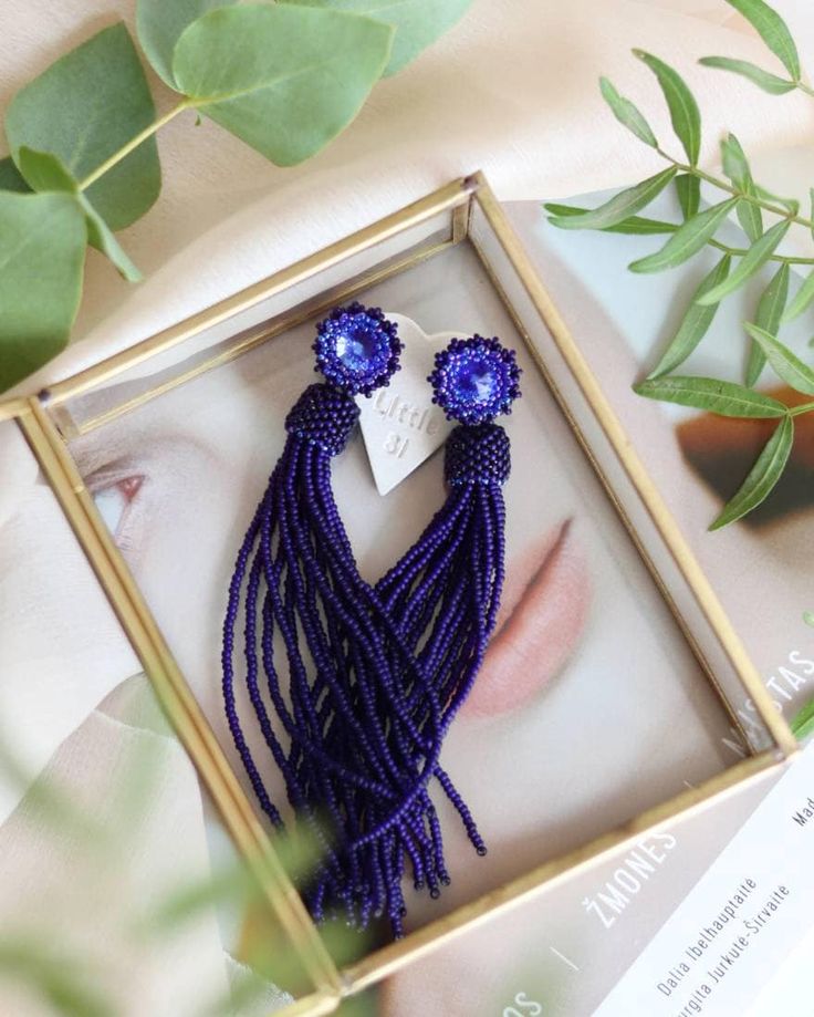 Add a touch of elegance to your outfit with these stunning matte blue beaded tassel earrings. The deep navy blue dangle earrings feature Swarovski crystal studs that add a hint of sparkle to your look. These bohemian-inspired fringe earrings are both trendy and chic, making them the perfect accessory for any occasion. Whether you're dressing up for a special event or adding a stylish touch to your everyday outfit, these seed bead earrings are sure to make a statement. Elevate your style with the Blue Dangle Tassel Earrings With Fringe, Blue Fringe Tassel Earrings For Party, Elegant Tassel Earrings With Round Dangling Beads, Chic Dangle Tassel Earrings As Gift, Elegant Beaded Fringe Jewelry, Chic Handmade Earrings For Evening, Blue Fringe Dangle Chandelier Earrings, Tassel Drop Earrings For Evening, Blue Long Drop Tassel Jewelry