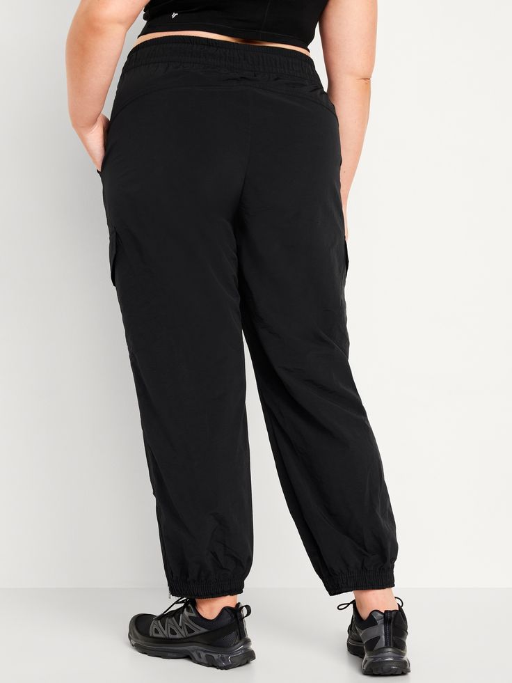 elastic-drawstring waist faux fly front pockets flap-cargo pockets at thigh side-zip hem elasticized cuffs sits at belly button loose hip and thigh tapered leg hits at ankle 29" regular inseam 27" petite inseam 32" tall inseam models are approx.  5'9" and wear sizes s (4), l (12), and xl (18)machine wash according to the care instruction label Stones Throw, Cargo Joggers, Jack Black, Petite Size, Belly Button, Tapered Legs, Jogger Pants, Drawstring Waist, Side Zip