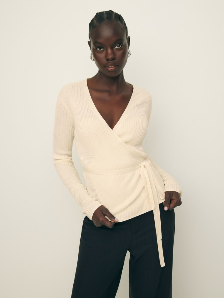 Layer up. Shop the Blaire Ribbed Wrap Cardigan from Reformation, a long-sleeve wrap cardigan with an adjustable tie. Chic Wrap Top For Winter, Elegant Wrap Top For Spring Layering, Elegant Spring Wrap Top For Layering, Fall Wrap Top, Chic Winter Wrap Top, Chic Wrap Sweater For Workwear, Fall V-neck Wrap Top With Tie Waist, Chic Wrap Sweater For Work, Fall Wrap Top With Tie Waist