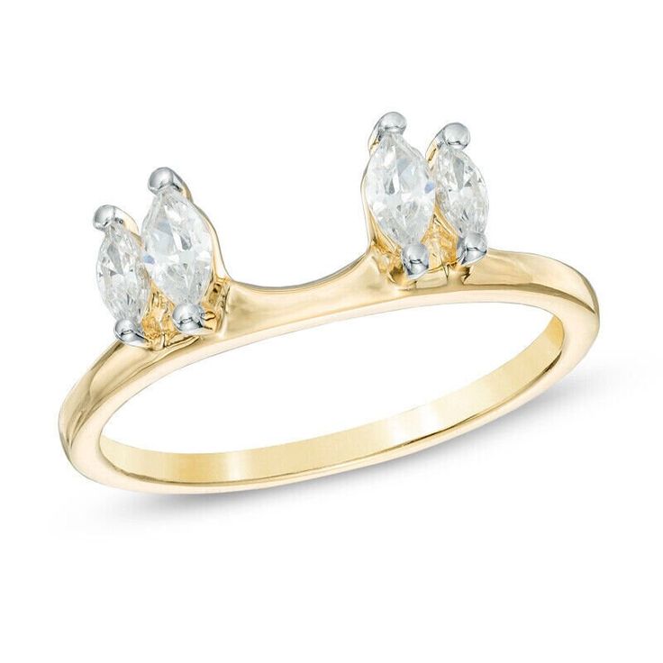 a yellow gold ring with three pear shaped diamonds